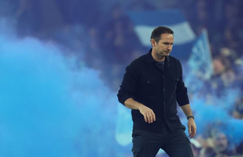 Everton manager Frank Lampard on the sidelines as fans let off smoke bombs. Action Images