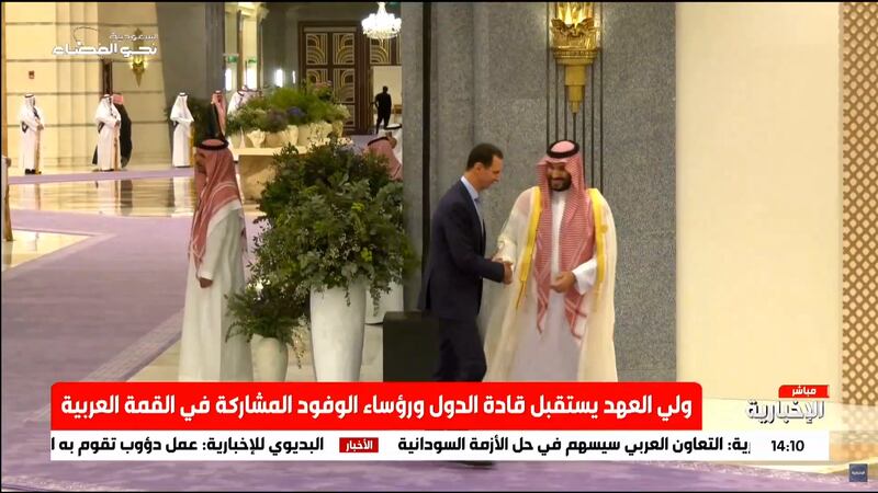 Prince Mohammed greets Mr Al Assad at the Arab League summit in Jeddah. 