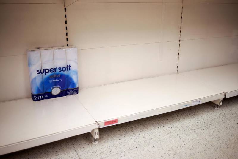 Toilet paper rolls are seen on an almost empty shelf as people shop at a Sainsbury's store, amid the outbreak, in London, Britain. Reuters
