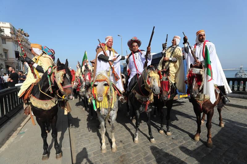 Algerian wearing traditional clothes perform during a parade held on the eve of the 31st Arab Summit and on the eve 68th anniversary of the outbreak of the War of Liberation, in Algiers, Algeria, 31 October 2022.  The celebrations of the 68th anniversary of the outbreak of the War of Liberation also coincides with the holding of the 31st Arab Summit in Algiers.  The 31st Summit of the Arab League is scheduled to take place in Algiers on 01 and 02 November.   EPA / MOHAMED MESSARA