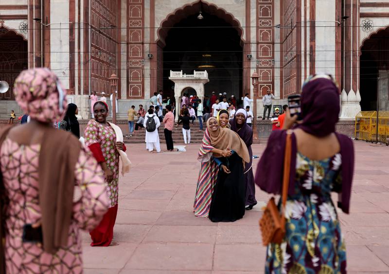 Nigerian Muslim women take pictures at Jama Masjid on the occasion of Eid Al Adha, in the old quarters of Delhi. Reuters
