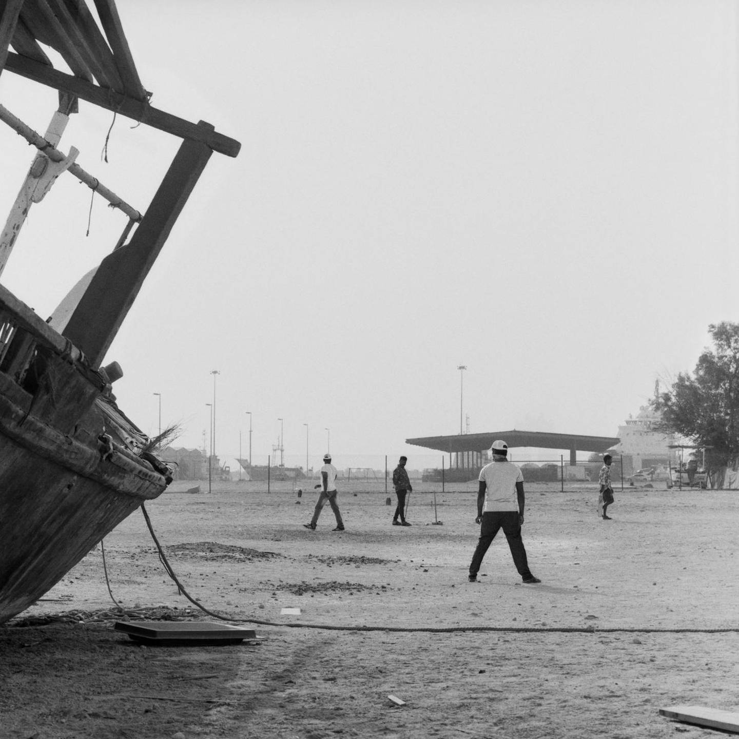Mazna Almazrouei looks at the role of public space by photographing cricket players in abandoned pockets of Mina Zayed. Courtesy of the artist