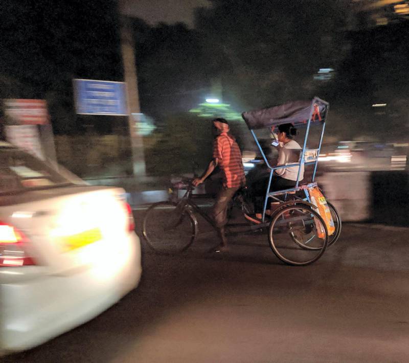 A rickshaw puller ferrying a passenger in New Delhi on Thursday as air quality continuous to remain in hazardous category. Taniya Dutta for The National 