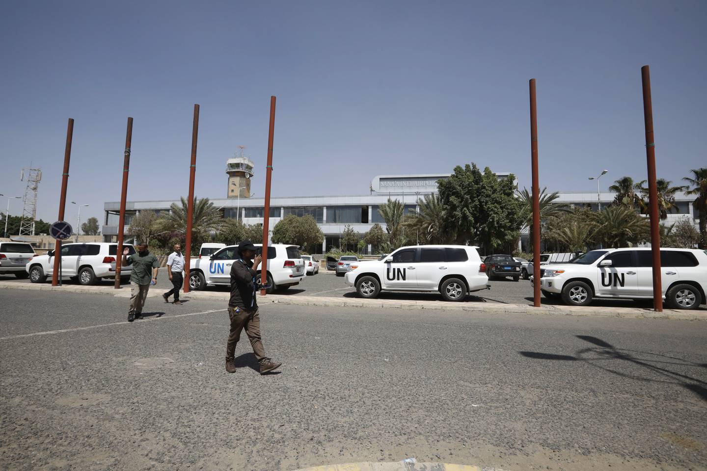 UN staff members walk past UN vehicles parking at SanaaΩ airport, in Sanaa, Yemen, 08 June 2022. EPA