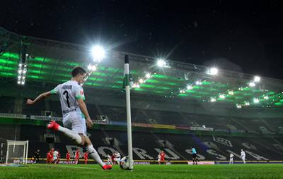 MOENCHENGLADBACH, GERMANY - MARCH 11: General view of the empty stadium as Patrick Herrmann of Borussia Monchengladbach takes a corner during the Bundesliga match between Borussia Moenchengladbach and 1. FC Koeln at Borussia-Park on March 11, 2020 in Moenchengladbach, Germany. For the first time in the history of the German Bundesliga the match is played behind closed doors as a precaution against the spread of COVID-19 (Coronavirus). (Photo by JÃ¶rg SchÃ¼ler/Bongarts/Getty Images)