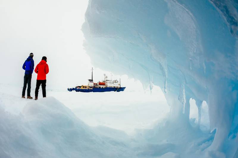 This image taken by expedition doctor Andrew Peacock of www.footloosefotography.com on December 30, 2013 shows the ship MV Akademik Shokalskiy (C) still stuck in the ice off East Antarctica, as it waits to be rescued.   An Australian icebreaker was on December 30 battling against bad weather to reach a ship carrying a scientific expedition stranded off Antarctica, leaving open the possibility of a helicopter evacuation, authorities said.  The ship is carrying scientists and tourists who are following the Antarctic path of explorer Douglas Mawson a century ago, details of which at www.spiritofmawson.com, and have been carrying out the same scientific experiments his team conducted during the 1911-1914 Australian Antarctic Expedition -- the first large-scale Australian-led scientific expedition to the frozen continent.          RESTRICTED TO EDITORIAL USE         AFP PHOTO / MANDATORY CREDIT: Andrew Peacock / www.footloosefotography.com / AFP PHOTO / footloosefotography.com / Andrew Peacock