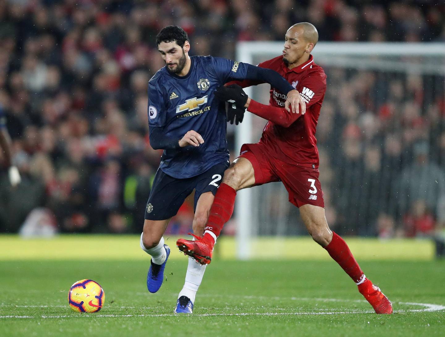 Soccer Football - Premier League - Liverpool v Manchester United - Anfield, Liverpool, Britain - December 16, 2018  Manchester United's Marouane Fellaini in action with Liverpool's Fabinho   Action Images via Reuters/Carl Recine  EDITORIAL USE ONLY. No use with unauthorized audio, video, data, fixture lists, club/league logos or "live" services. Online in-match use limited to 75 images, no video emulation. No use in betting, games or single club/league/player publications.  Please contact your account representative for further details.