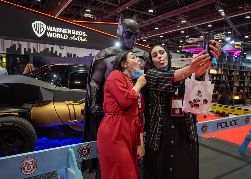 Comic Con visitors pose with Batman.