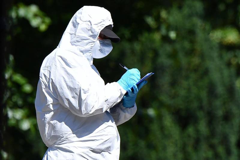 A police forensics officer works inside Forbury Gardens park in Reading, west of London, on June 22, 2020, the scene of the June 20 stabbing spree.  AFP