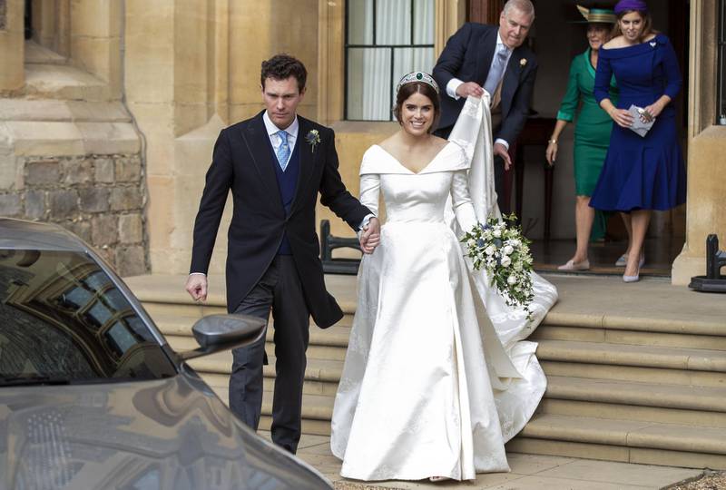 Princess Eugenie and Jack Brooksbank helped by Princess Beatrice and Prince Andrew, Duke of York leave Windsor Castle after their wedding for an evening reception at Royal Lodge on October 12, 2018 in Windsor, England. Getty Images