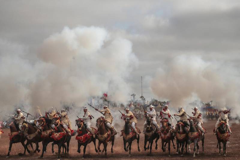 A troupe charges and fires their rifles during Tabourida, a traditional horse riding show also known as Fantasia, in the coastal town of El Jadida, Morocco.