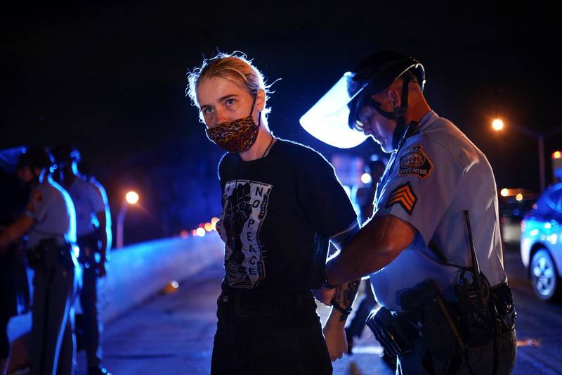 Police detain a protester for blocking traffic during a rally against racial inequality and the police shooting death of Rayshard Brooks, in Atlanta, Georgia. Reuters