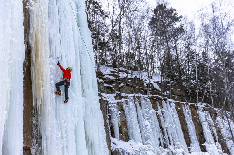 Susan Hill climbs a rock wall covered with ice during the Sandstone Ice Climbing festival at Robinson Ice Park in Sandstone, Minnesota. AFP