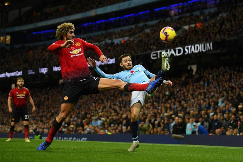 Marouane Fellaini of Manchester United battles for possession with Bernardo Silva of Manchester City. Getty