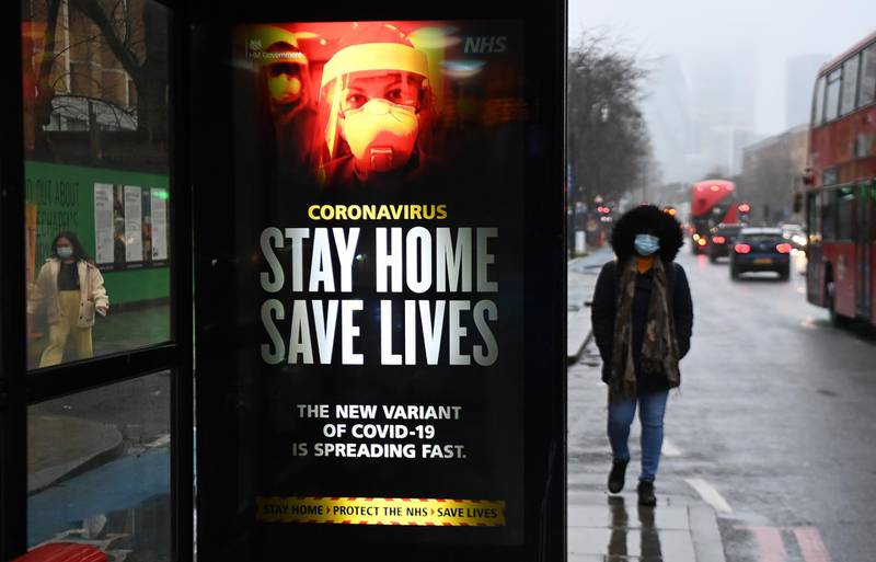 A public health notice to 'stay home' is seen at a bus stop in London. EPA