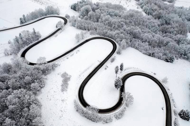 A drone picture shows a road running through snow-covered fields in the village of Izdebki, south-eastern Poland, on  December 8. EPA
