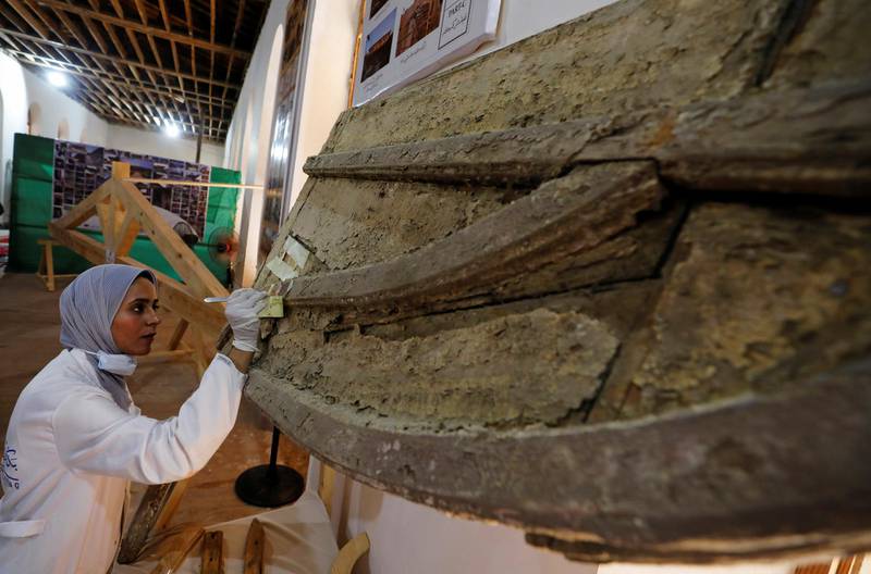 An archaeologist works on objects at the Suez Canal International Museum as Egypt celebrates the 150th anniversary of the canal opening in Ismailia, Egypt. Reuters