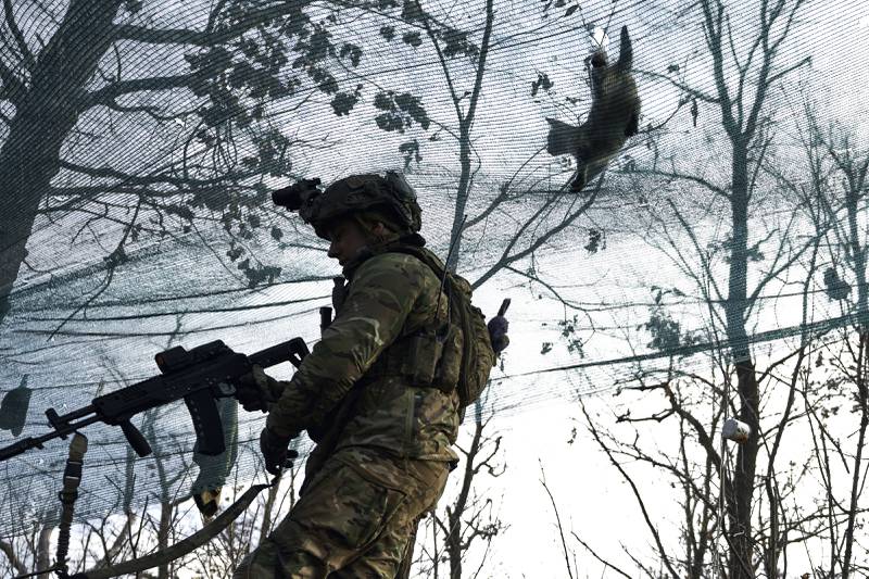 A cat walks on top of a net as a Ukrainian soldier takes position during fighting against Russian forces near Maryinka, Donetsk region. AP