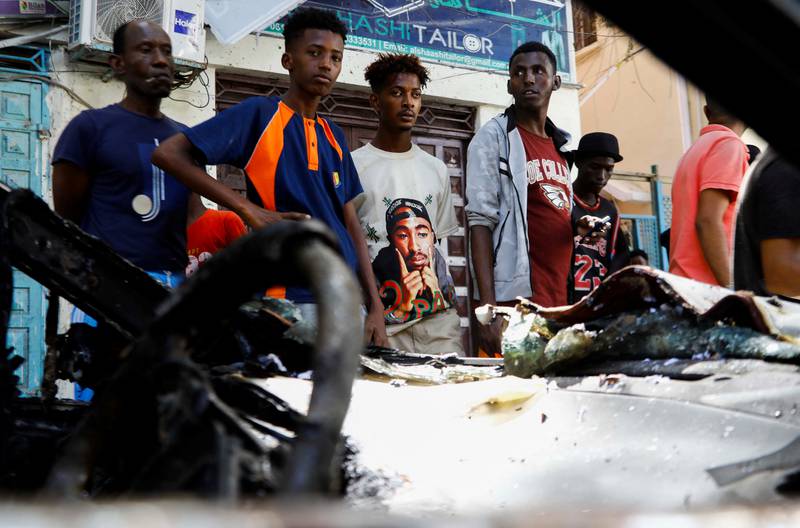 Somalis look at the wreckage of a vehicle destroyed at the scene of the explosion. Reuters
