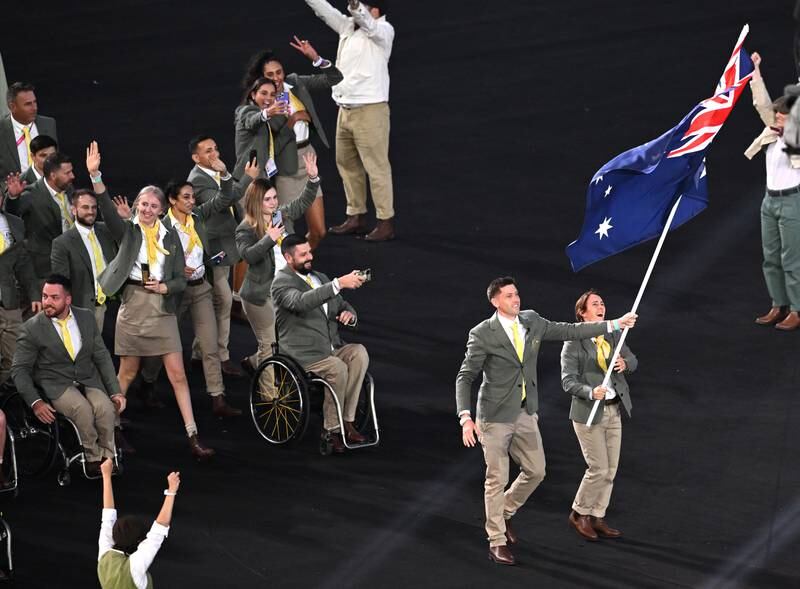Flagbearers Eddie Ockenden and Rachael Grinham lead Team Australia. EPA