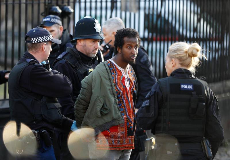 Armed police speak to a man after tasering him. Reuters
