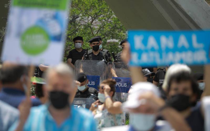 Turkish police officers watch a demonstration in Istanbul against President Recep Tayyip Erdogan's canal project. AP Photo