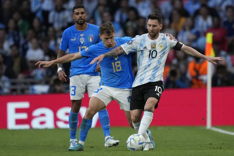 Italy's Nicolo Barella and Lionel Messi battle for the ball. AP