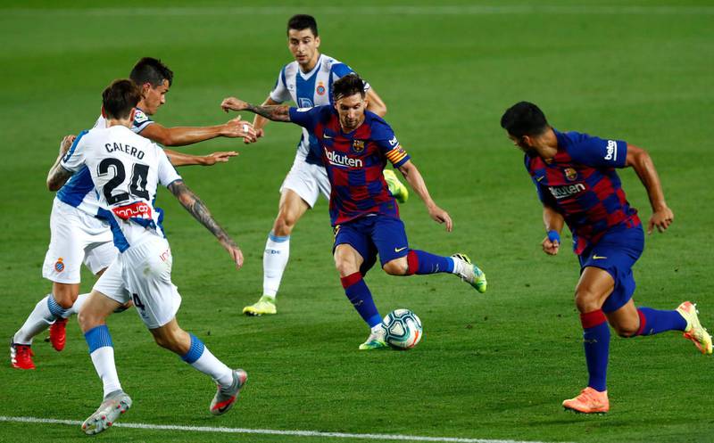 Barcelona's Lionel Messi runs with the ball against Espanyol's Marc Roca, Fernando Calero and Bernardo Espinosa, left. AP Photo