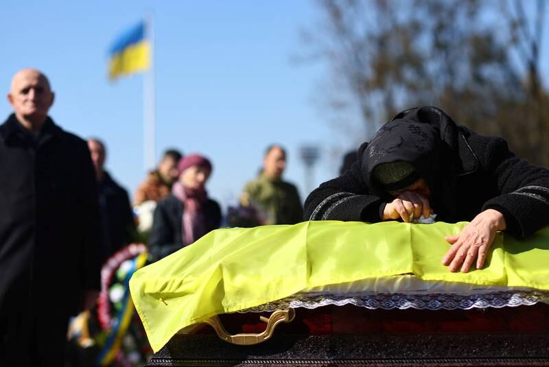 Family members and comrades of Ivan Skrypny, who was killed in a rocket attack on a military base in Yavoriv, pay their last respects at his memorial service in Lviv, Ukraine. Reuters