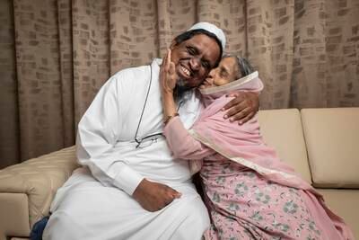 Abida Siraj, 75, who was born in India, moved to Pakistan after marriage and then to Dubai, embraces her son Khalid, who was born in the emirate. Antonie Robertson / The National
