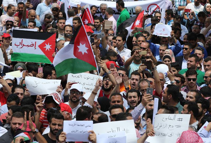 Thousands of Jordanians take to the streets of Amman to protest the bill. Khalil Mazraawi / AFP