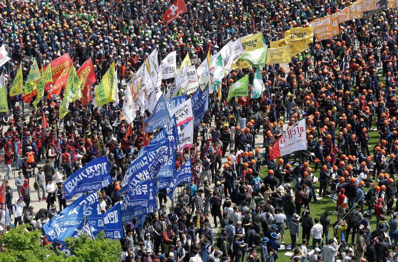 Members of the Korean Confederation of Trade Unions carry their union flags during a May Day rally in Seoul. AP Photo