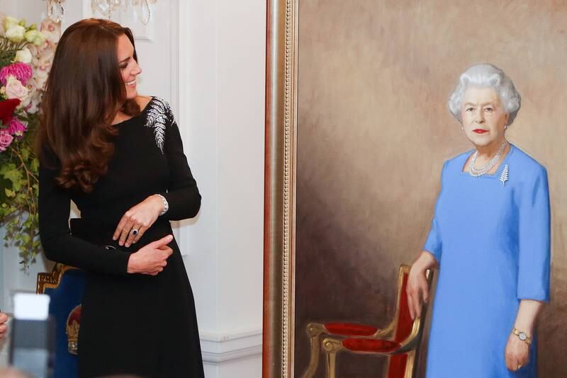Catherine, Duchess of Cambridge inspects a portrait of Queen Elizabeth painted by New Zealand artist Nick Cuthell and unveiled during a state reception in Wellington, in 2014. Getty Images