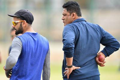 India Test cricket captain, Virat Kohli (L) and head coach Anil Kumble look on during a practice session at the National Cricket Academy (NCA) in Bangalore on July 1, 2016. The Indian team is taking part in a preparatory camp ahead of their West Indies Test tour. Majunath Kiran / AFP
