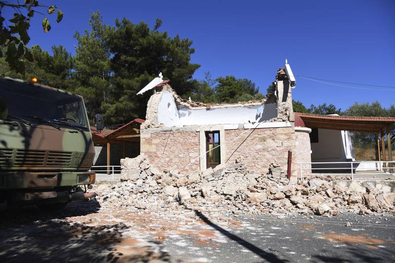 A military lorry passes a damaged Greek Orthodox church in Arkalochori village. Photo: AP