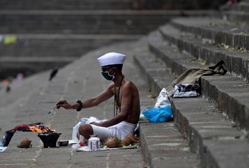 A Hindu devotee performs rituals in Mumbai. AP