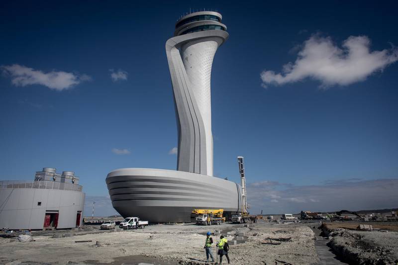 ISTANBUL, TURKEY - OCTOBER 06:  Airport employees are seen working in front of the control tower at the Istanbul New Airport (Istanbul Yeni Havalimani) on October 6, 2018 in Istanbul, Turkey. Construction continues around the clock on Istanbul's new third airport mega project. The official opening of the first phase of the new mega-hub is set to take place on October 29th, 2018. The first phase includes two runways, a terminal and is expected to have an annual passenger capacity of 90 million. Once all four phases of construction are completed the airport will service 100 airlines, flying to more than 350 destinations and will have an annual passenger capacity of 200 million making it the biggest air travel hub in Europe and one of the largest airports in the world. 36,000 employees are working round-the-clock on the 7,659-hectare construction zone, which has been under construction for more than three and a half years and all stages are expected to be completed by 2025 at a cost of approximately 10.2 billion euros. The airport is a centerpiece of a 15-year construction boom involving a series of mega projects under President Tayyip Erdogan, upon completion the airport will boast six runways, 165 aircraft jet bridges, four terminal buildings, hotels, a mosque, VIP lounges and have an indoor area of 16,000,000sq ft. Turkish Airlines will make the first overseas flight from the airport to Northern Cyprus and Azerbaijan.  (Photo by Chris McGrath/Getty Images)