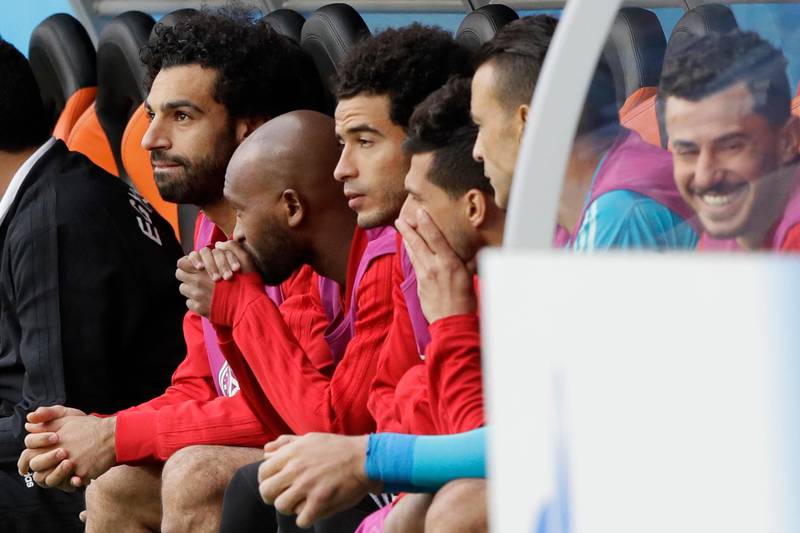 Egypt's Mohamed Salah, left, sits on the bench during the group A match between Egypt and Uruguay at the 2018 soccer World Cup in the Yekaterinburg Arena in Yekaterinburg, Russia, Friday, June 15, 2018. (AP Photo/Mark Baker)