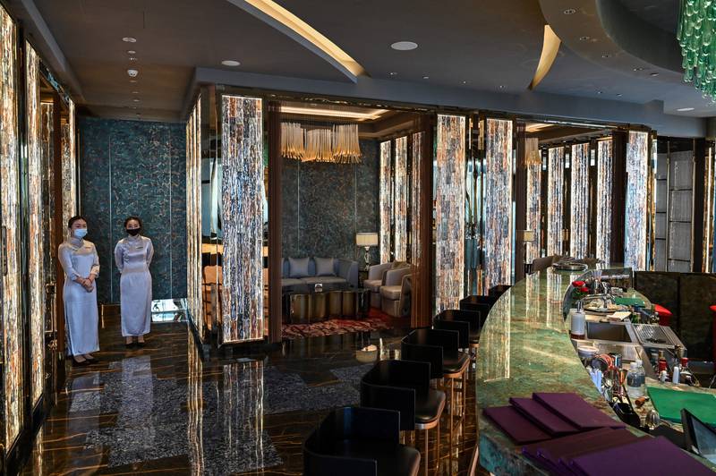 Employees stand in the bar of the J Hotel, the world's highest luxury hotel.