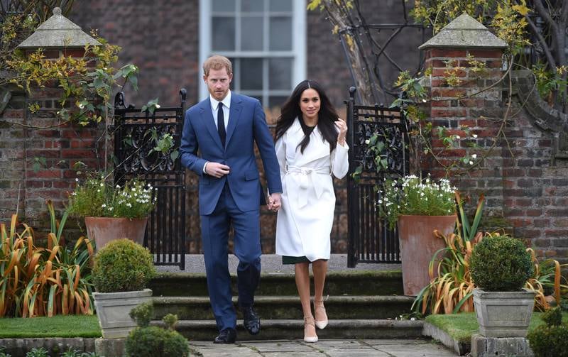 Prince Harry and Meghan Markle, in a coat by Line The Label, announce their engagement at The Sunken Gardens at Kensington Palace on November 27, 2017 in London, England