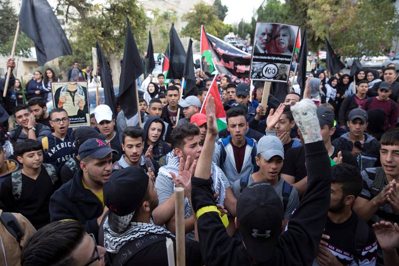 Young Palestinian protestors carry black flags and posters showing UK Prime Minister Theressa May and Arthur Balfour during a demonstration  in the Palestinian West Bank city of Ramallah on November 2, 2017. Demonstrations took place across the West Bank and Jerusalem ,marking  the 100th anniversary of Britain's Balfour Declaration, which helped lead to Israel's creation and the Israeli-Palestinian conflict.(Photo by Heidi Levine).