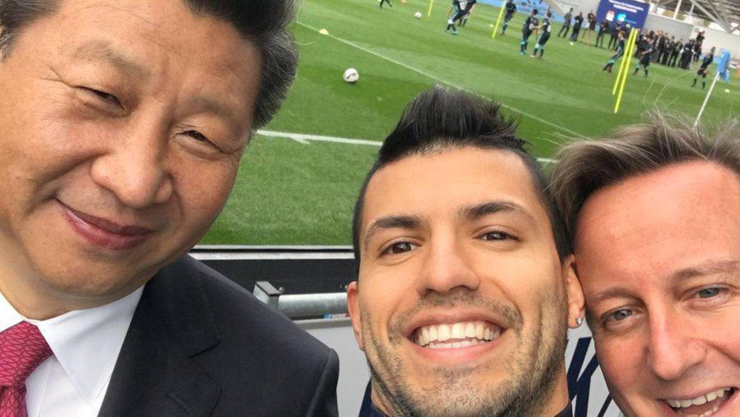 Manchester City striker Sergio Aguero takes a selfie with Chinese President Xi Jinping and former British Prime Minister David Cameron during a visit to the club's academy in 2015. 