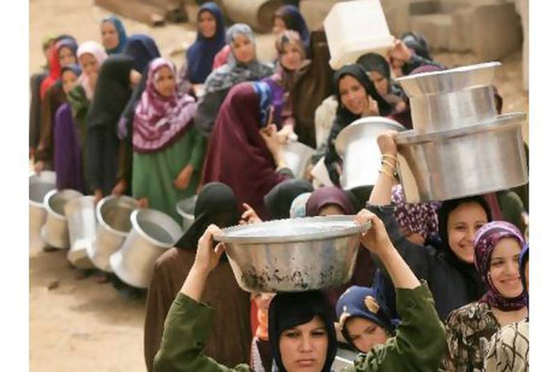 Egyptian women wait in line to fill their containers with clean water northeast of Cairo. AFP