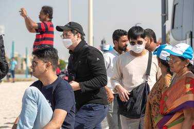 DUBAI, UNITED ARAB EMIRATES. 29 JANUARY 2020. Tourists and sightseers wear facial masks on Sunset Beach next to the Burj Al Arab and Jumeirah Beach Hotel. (Photo: Antonie Robertson/The National) Journalist: Standalone. Section: National.