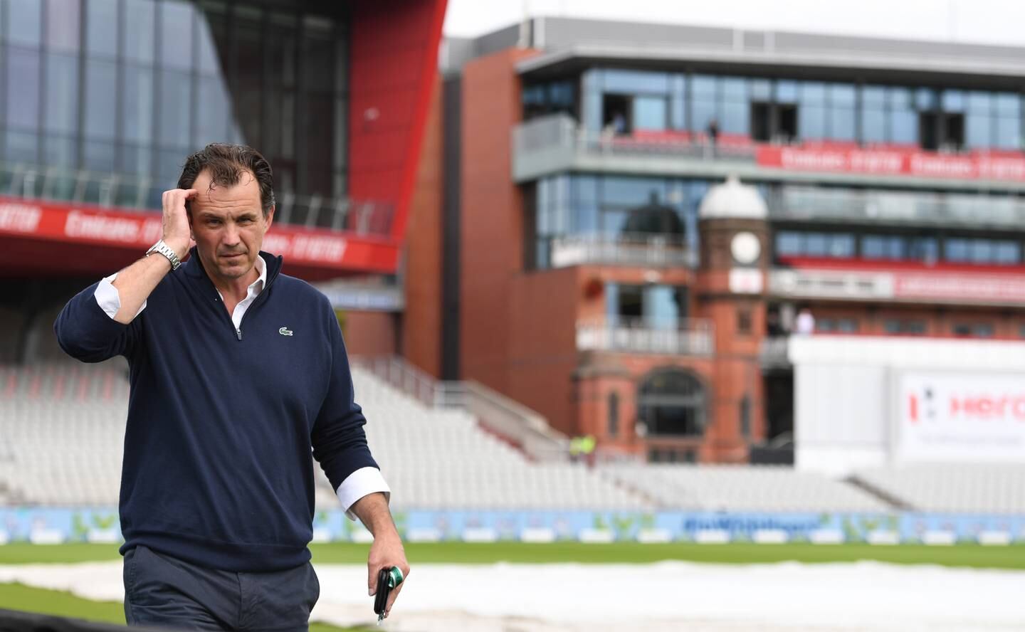 ECB chief executive Tom Harrison walks around the Old Trafford pitch. Getty Images
