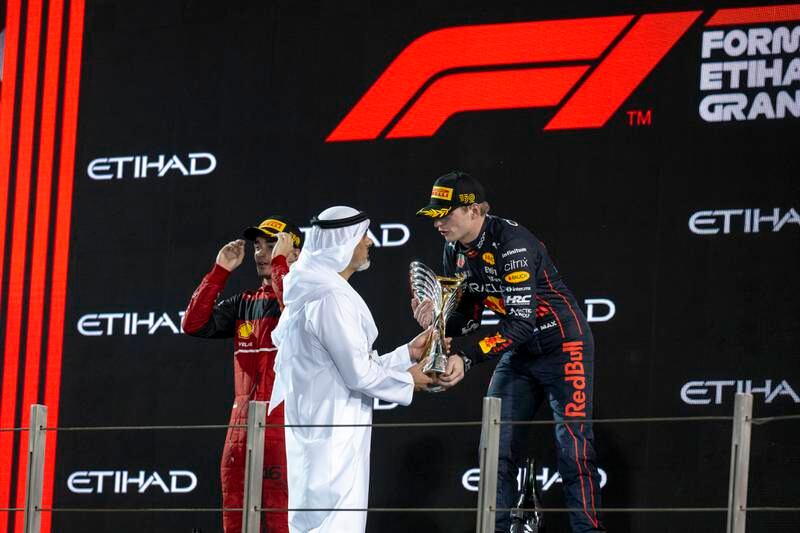 Sheikh Khaled bin Mohamed, chairman of the Abu Dhabi Executive Office, presents the trophy to the Abu Dhabi Formula One Grand Prix winner Max Verstappen of Red Bull. Photo: Mohamed Al Hammadi / UAE Presidential Court