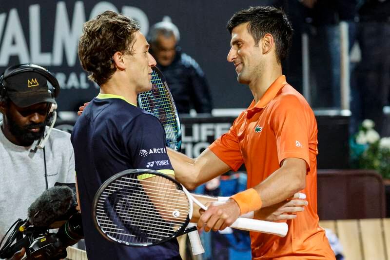 Novak Djokovic and Casper Ruud greet each other at the net following their Italian Open semi-final. EPA