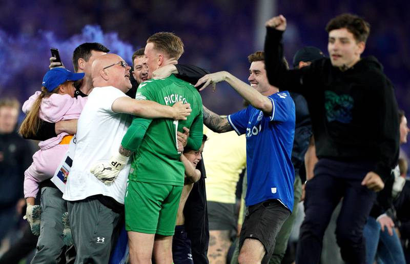 Fan run on to the pitch and mob Everton goalkeeper Jordan Pickford after the Premier League win against Crystal Palace at Goodison Park. PA