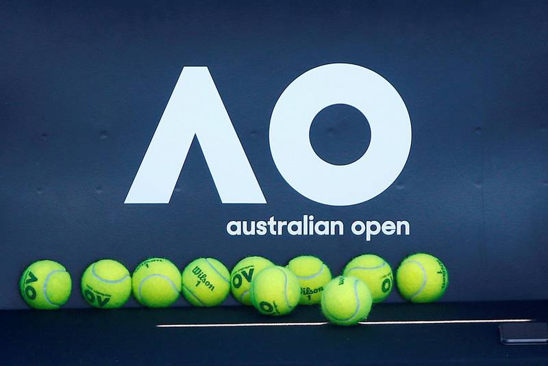 Tennis balls are pictured in front of the Australian Open logo. Reuters