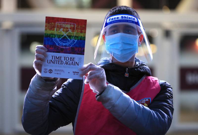 A programme seller wearing a face mask at the London Stadium. AP